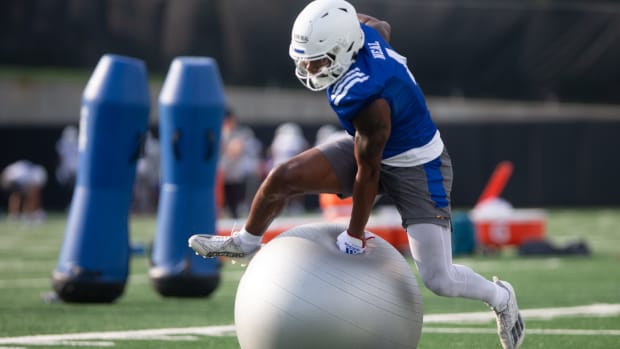 Kansas junior running back Devin Neal (4) jumps over an obstacle during Tuesday's outdoor practice.  